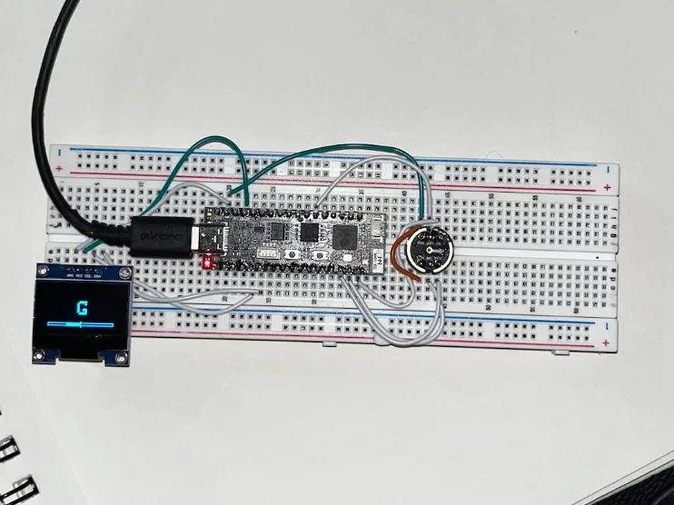 The Tiny Tuner prototype wired on a breadboard with its OLED display