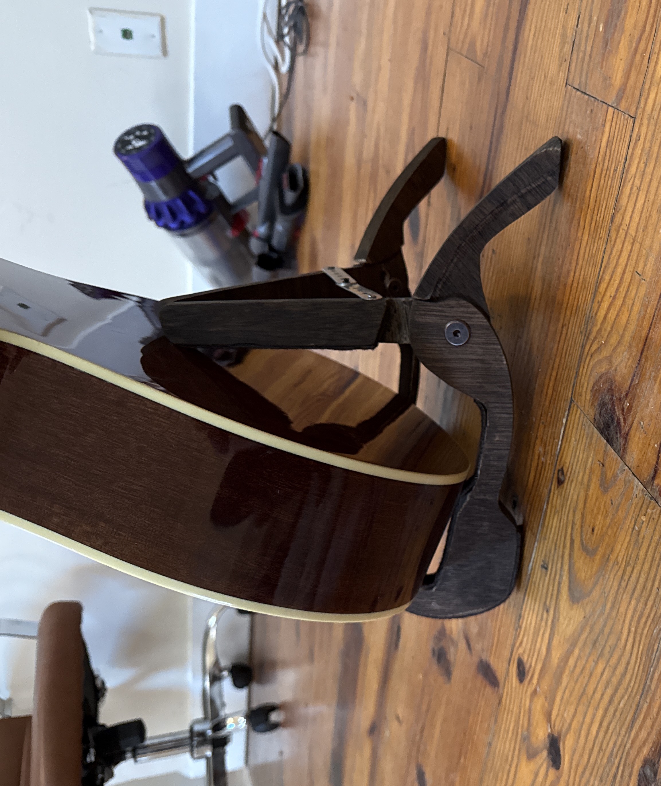 Acoustic guitar resting on stand