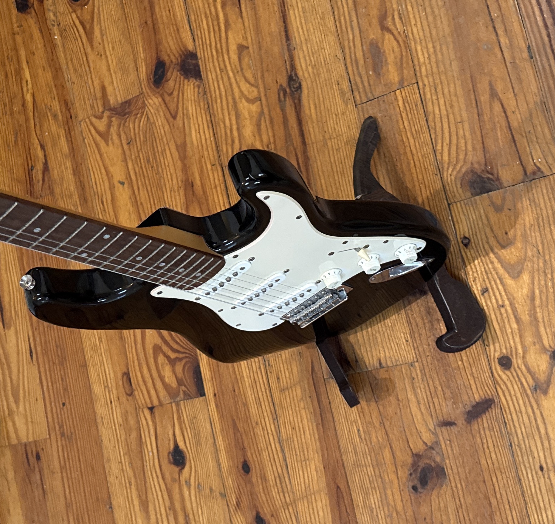 Electric guitar resting on stand