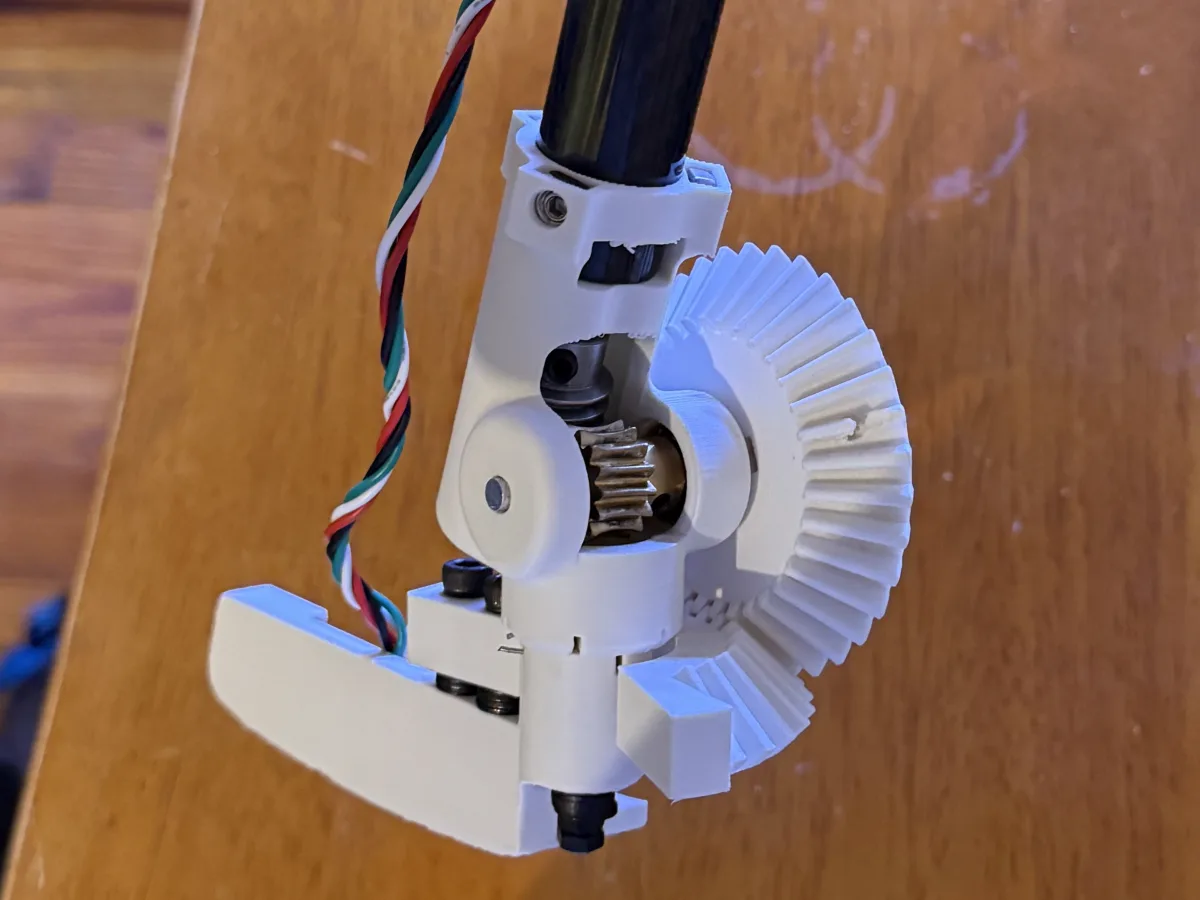 The MK 0 head assembly: a brass worm meshing with a 3D printed beveled rack that pivots the putter blade